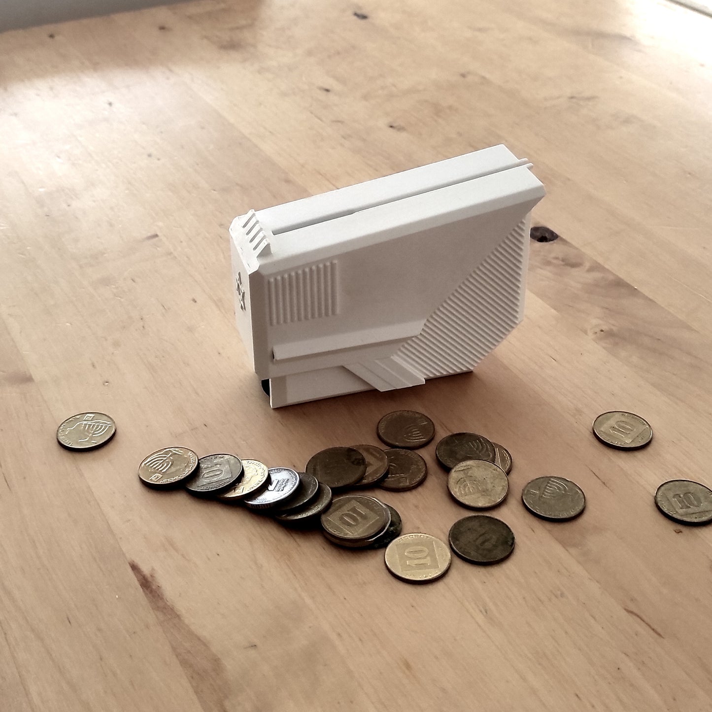 tzedakah box  ,   pushke   ,    money box   ,    piggybank